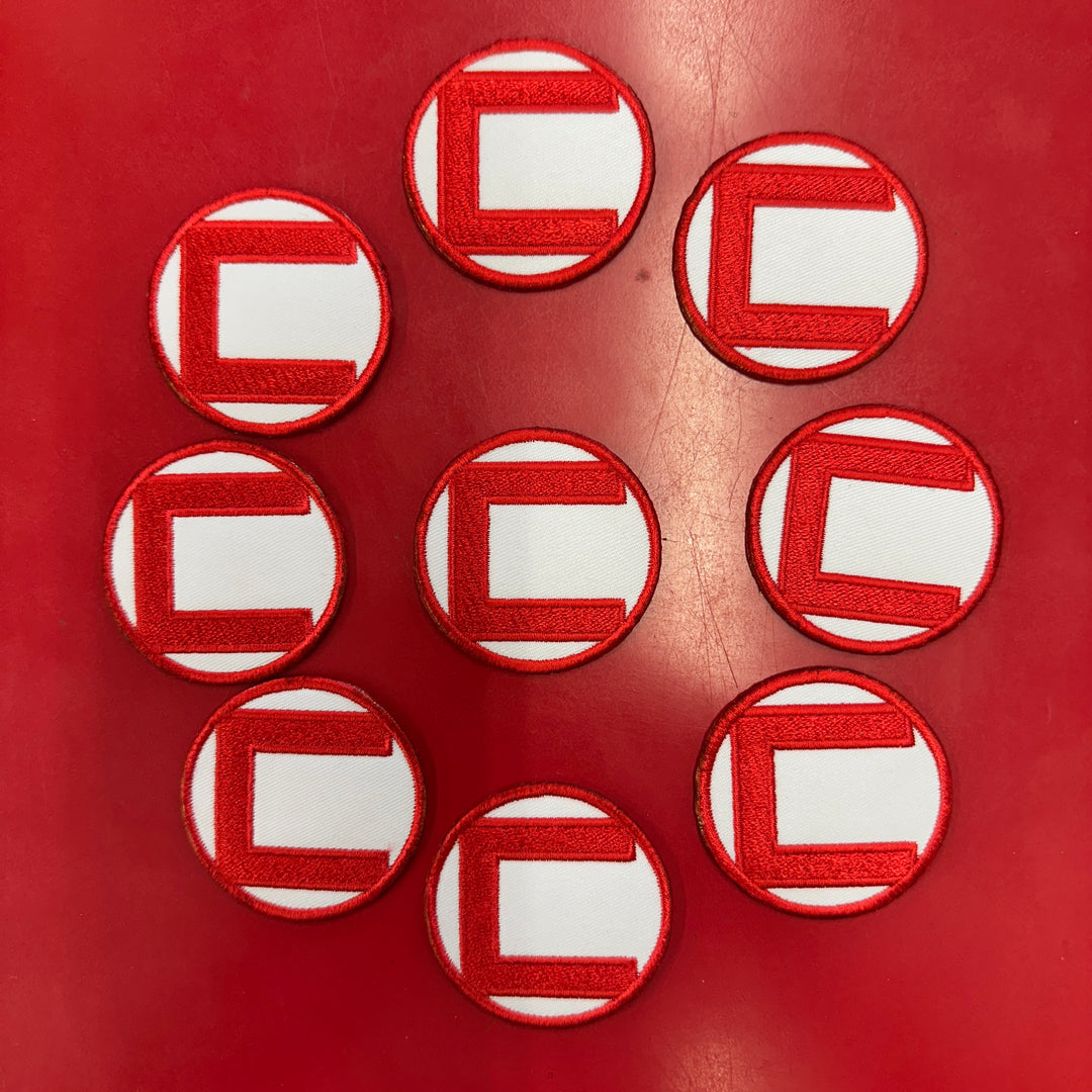 2-inch red and white circular patches with a red letter 'C' on a white background